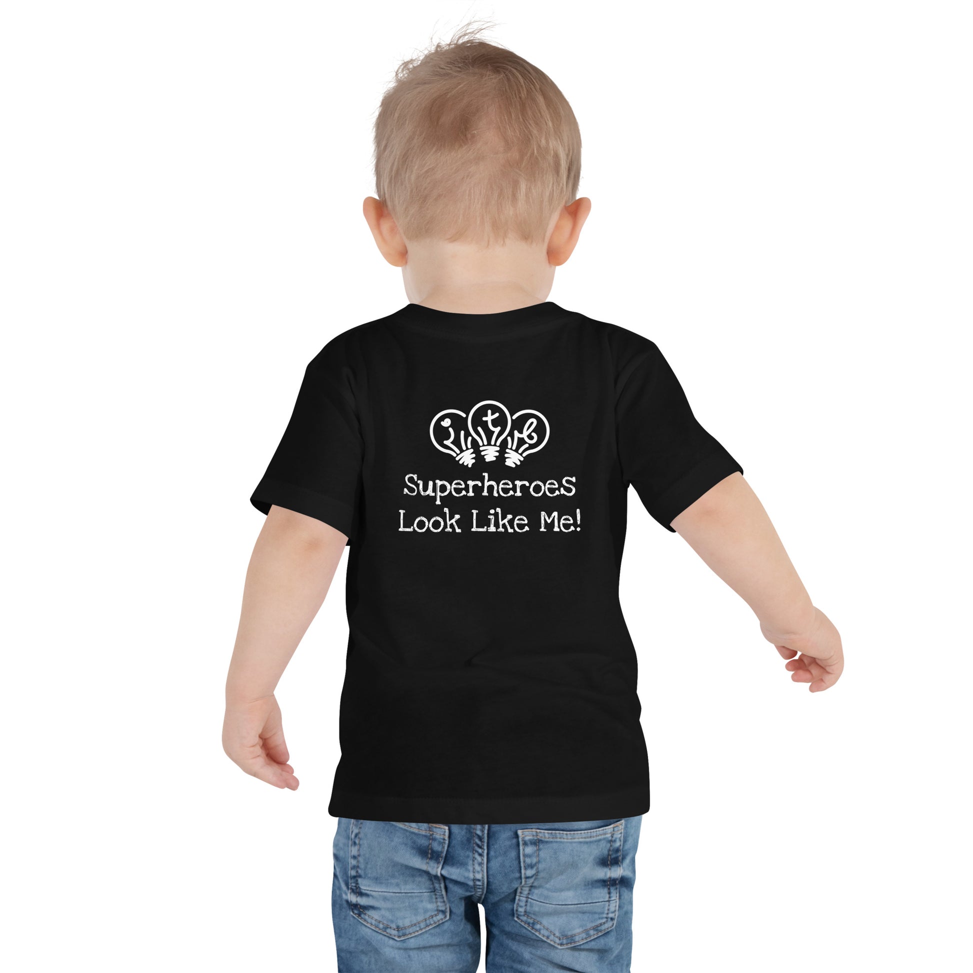 Black toddler t-shirt with an image of the main character from Crystel Patterson's "Superheroes Here and There" wearing a cape (front) and the text "Superheroes Look Like Me" (back).