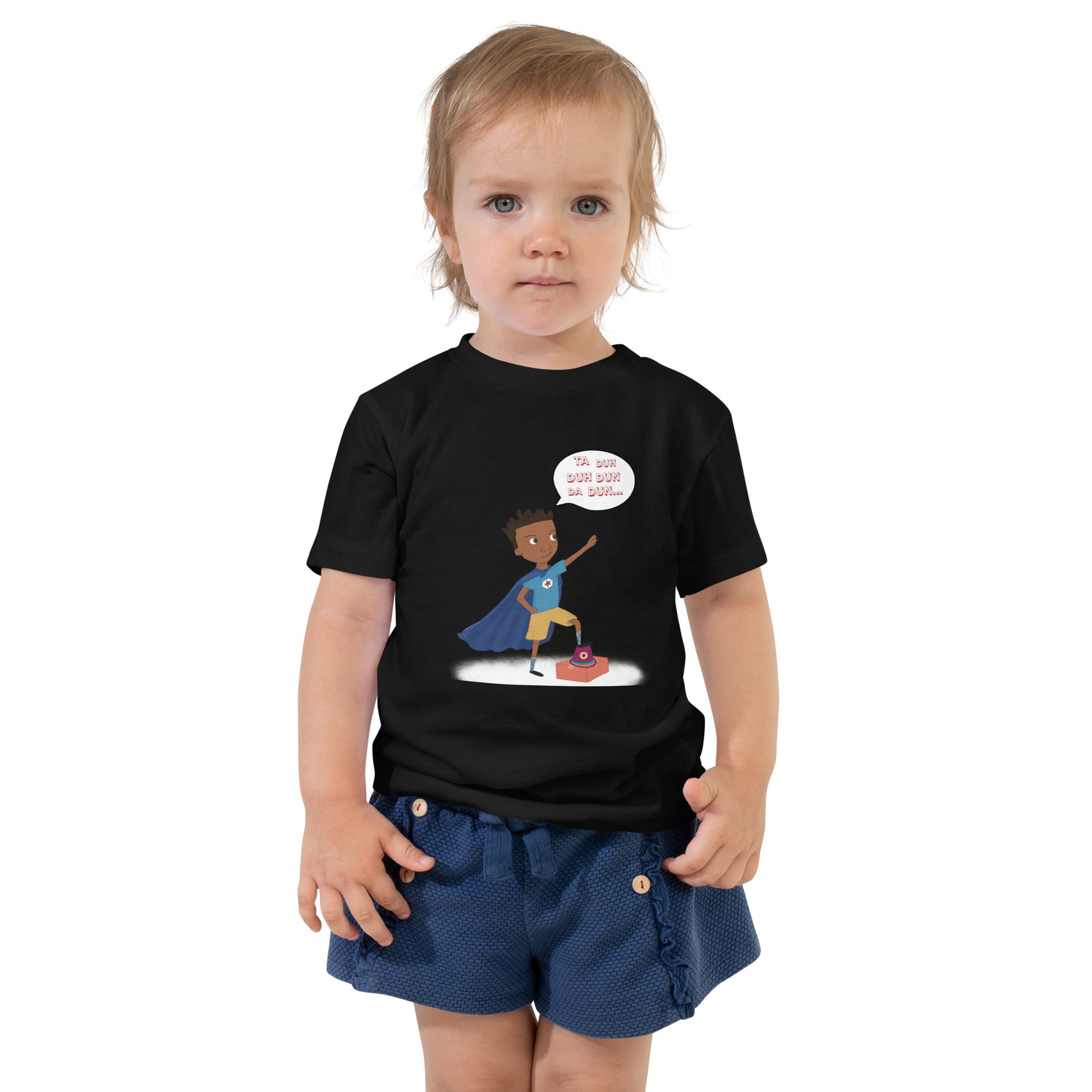 Black toddler t-shirt with an image of the main character from Crystel Patterson's "Superheroes Here and There" wearing a cape (front) and the text "Superheroes Look Like Me" (back).