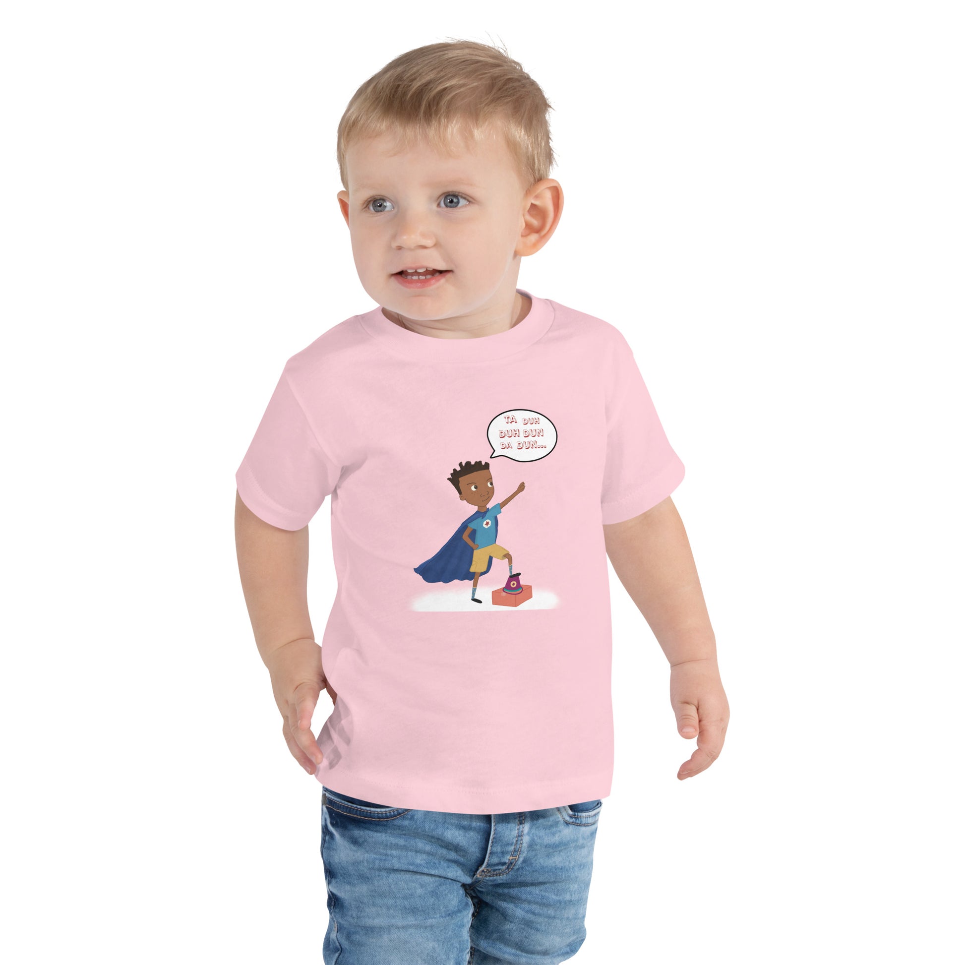 Pink toddler t-shirt with an image of the main character from Crystel Patterson's "Superheroes Here and There" wearing a cape (front) and the text "Superheroes Look Like Me" (back).